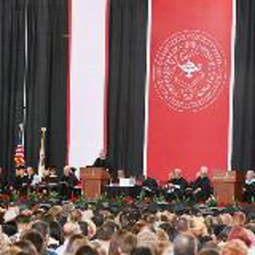 red and black back drop curtain in crowd and speakers