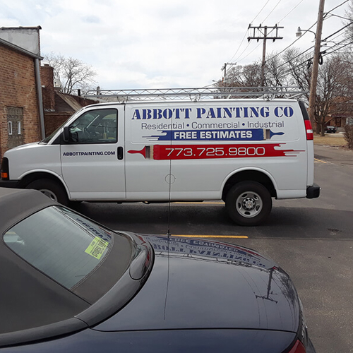 Abbot painting truck wrapped with letterings and graphics parked outside the building