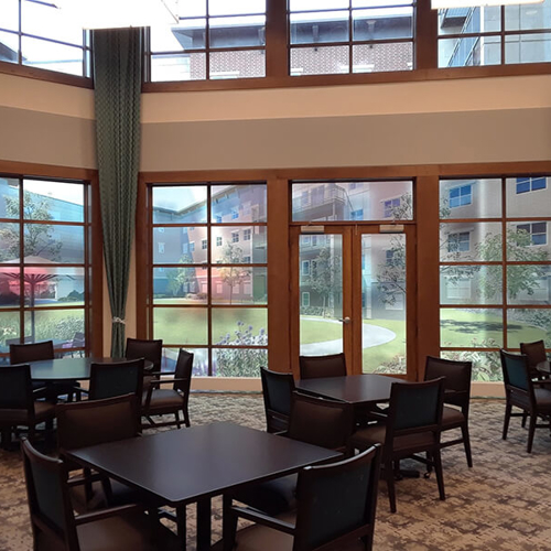 The Carrington at Lincolnwood lobby with lettering on the door and chair and tables