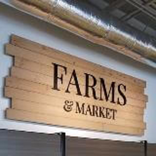 Farms & market signage on the store with products below the sign