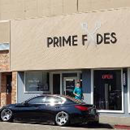 Prime Fides sign on the store with cars parked