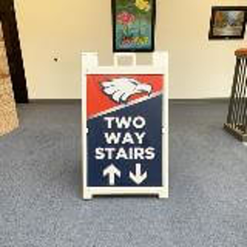 Two way stairs frame sign along the school hallway